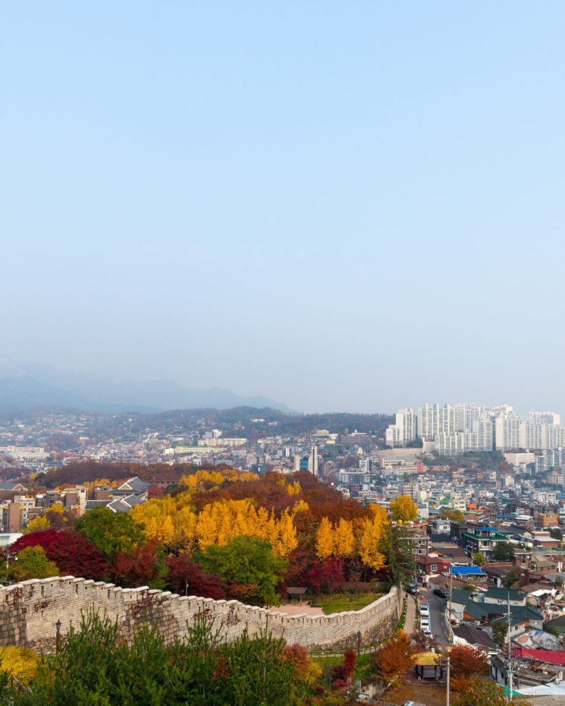 Historic Seoul City Wall with autumn-colored trees and city views